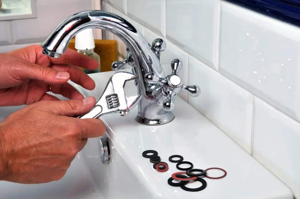 Plumber performing maintenance on a bathroom faucet in Camas