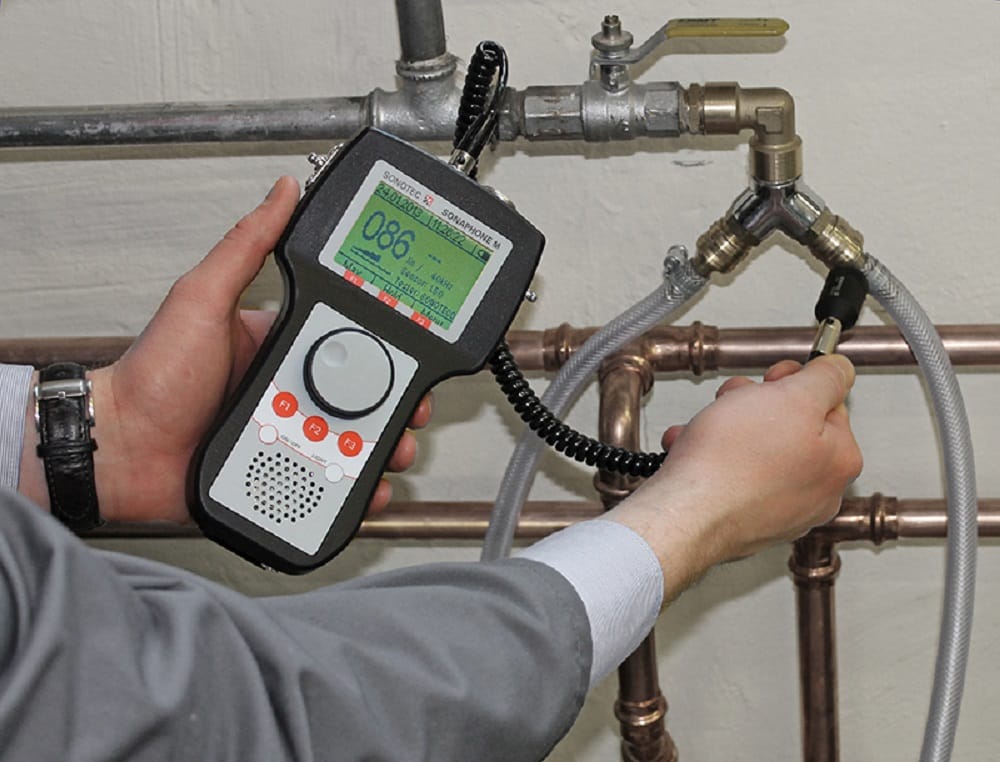 Plumber testing pipes with electronic leak detection equipment in Camas