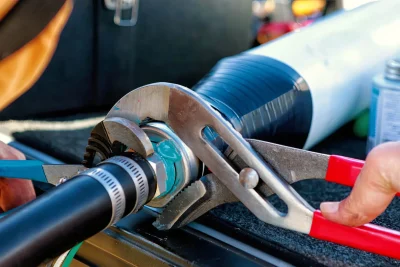 Technician tightening an industrial pipe connection in Camas