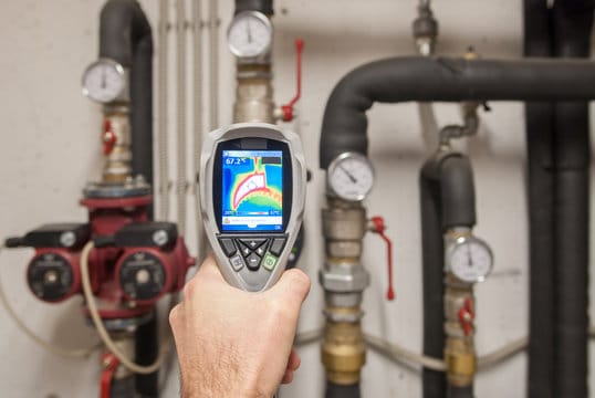 Plumber using a thermal imaging camera to inspect pipes in Camas