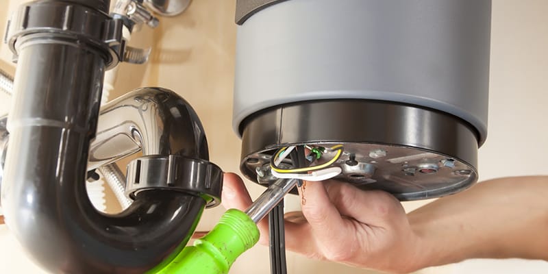 Technician repairing the heating element of a water heater in Camas