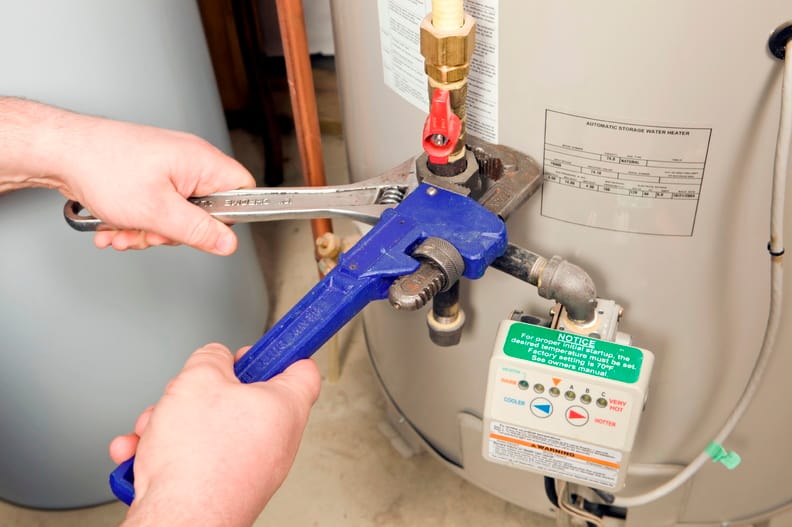 Plumber repairing a water heater valve in Camas